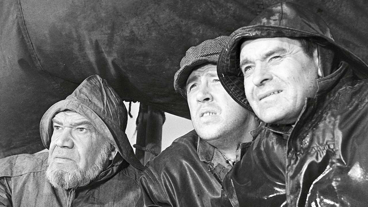 Men from the Fisherman's Village backdrop