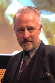 Photo of Bryan Moore as DJ Voice (voice)