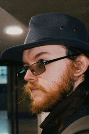 Photo of Mikie Holmes as Camera Shop Employee