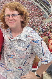 Photo of Logan Busbee as Head Coach Brian