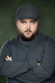 Photo of Rhys Walby as The Producer (Uncredited)
