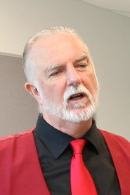 Photo of John Holland as Mr. Trison