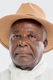 Photo of Bienvenu Neba as Commissaire Djama (vieux)