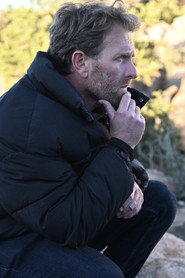 Photo of Travis Mills as Gun Shop Owner