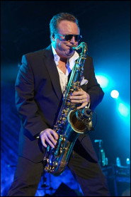 Photo of Brian Travers as Saxofón