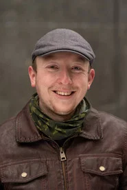 Photo of Kris Scott as Historian Patrick