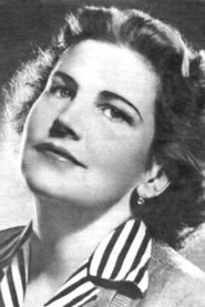 Photo of Klára Pápai as Bozine, the party secretary