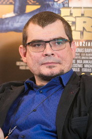 Photo of Emilis Vėlyvis as Kunigas