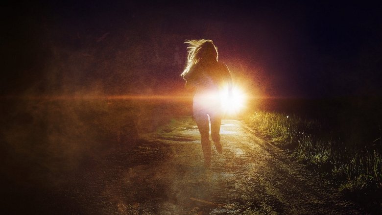 A dimly lit road at night, the headlights of a car cutting through the darkness, casting long shadows.