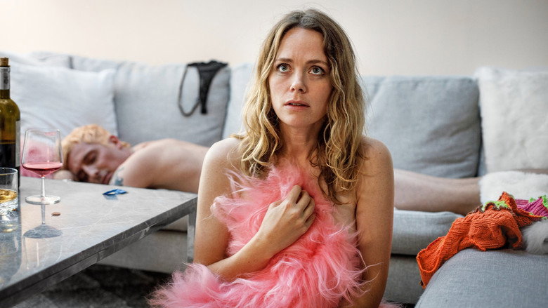 Hanna sitting alone in a dimly lit room, her expression a mix of exhaustion and defiance