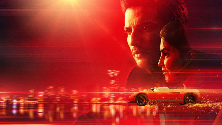 The gang gathers under neon lights, cars revving in slow motion