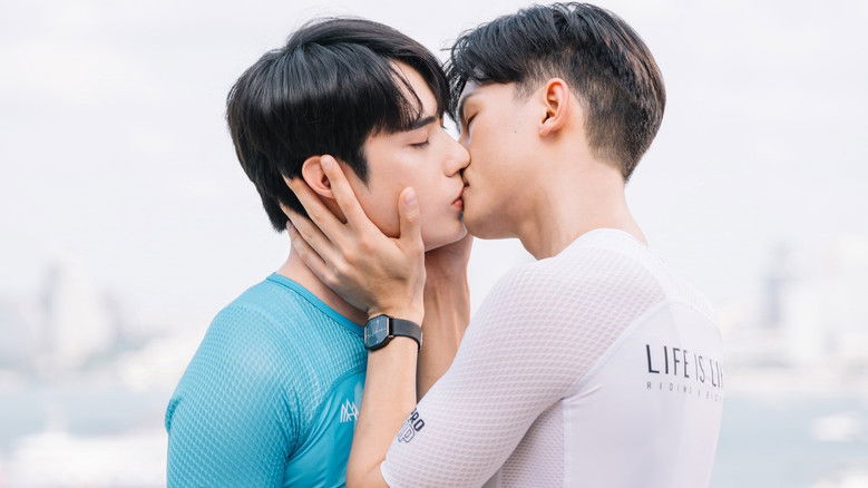 A wide shot of the brothers silhouetted against a setting sun while riding their bikes.