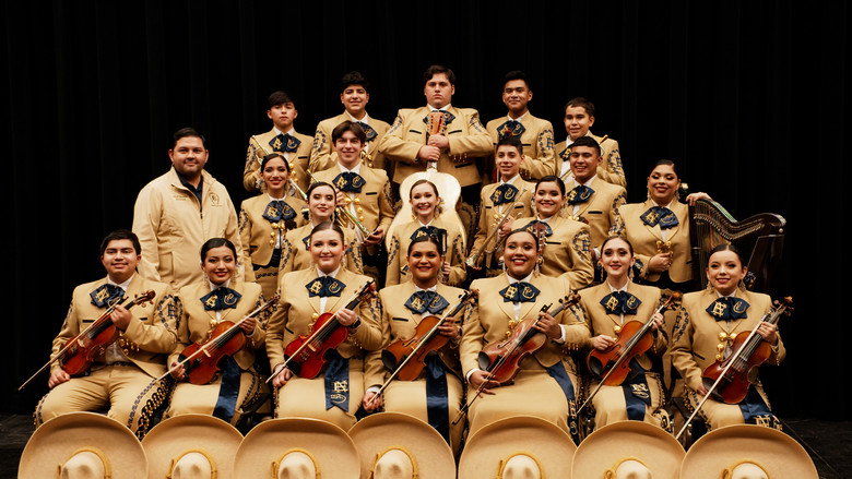 A dimly lit stage, the glow of a single spotlight catching the gold embroidery of a mariachi jacket as a student adjusts their grip on a violin.