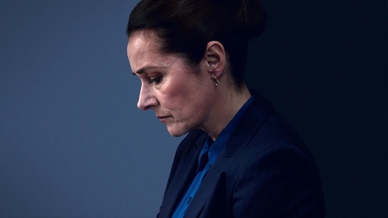 A dimly lit press conference, Birgitte Nyborg standing at a podium, her face half in shadow, the weight of the room pressing down on her.