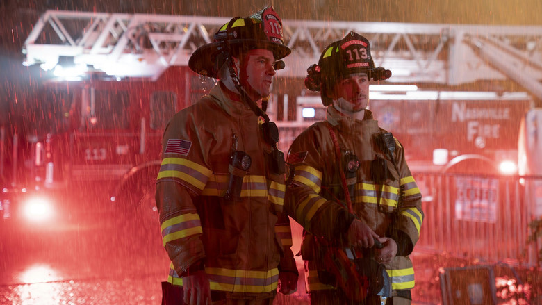 A chaotic, high-contrast night scene of first responders at an emergency site