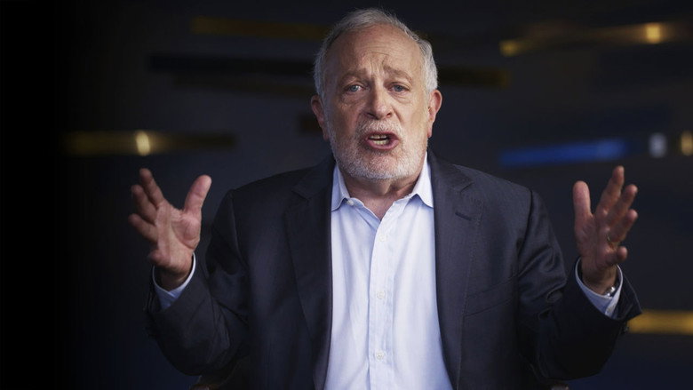 Reich speaking to a small group in a diner, his hands animated, the camera close enough to catch the earnestness in his eyes.