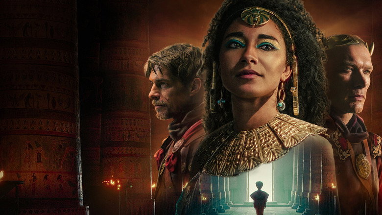 Adele James as Cleopatra, her face half-lit by torchlight, eyes fixed on some unseen threat beyond the frame