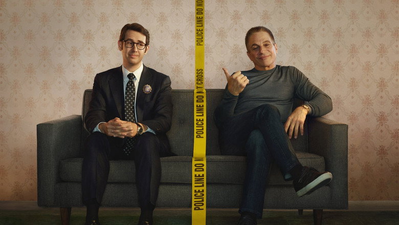 Tony Sr. and TJ stand in a dimly lit precinct, the glow of a desk lamp casting long shadows across their faces. The tension between them is palpable, a mix of frustration and reluctant affection.