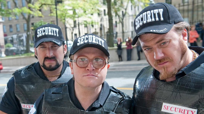 The trio stands in the wreckage of their latest failed scheme, the camera lingering on their exhausted expressions.