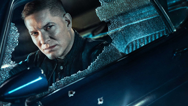 A sleek muscle car parked on a cold Chicago street at night