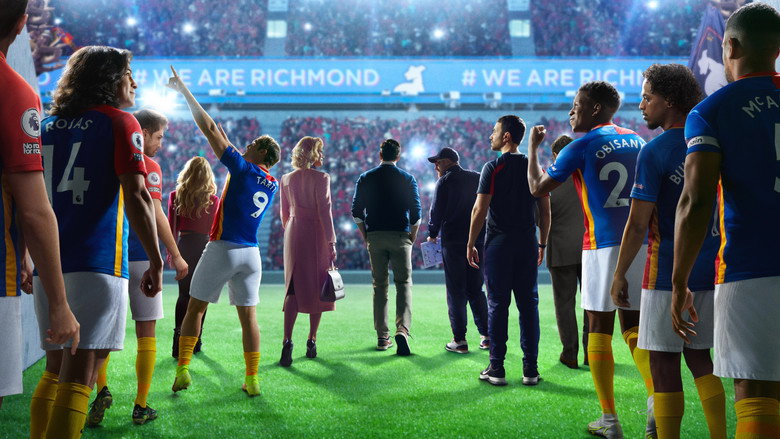 Ted Lasso stands in the locker room, arms outstretched, as his players watch him with a mix of skepticism and curiosity.