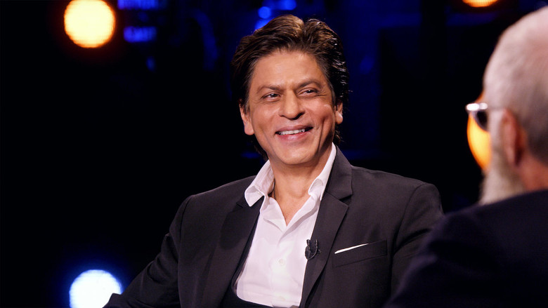 Letterman and Khan sit in a garden, the Mumbai skyline blurred in the background, their expressions relaxed yet engaged