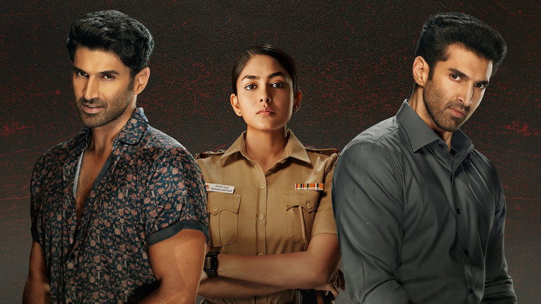 A tense interrogation scene, with Aditya Roy Kapur’s two characters framed in stark contrast—one under the harsh light of suspicion, the other in shadow