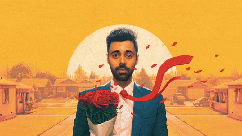 Hasan Minhaj on stage, mid-gesture, his face lit with a mix of humor and something sharper