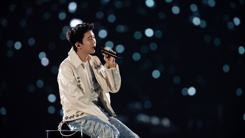 A sea of fans in rain ponchos, their phone lights glowing like fireflies in the dark, as Lim Young-woong performs under a downpour at Seoul World Cup Stadium.
