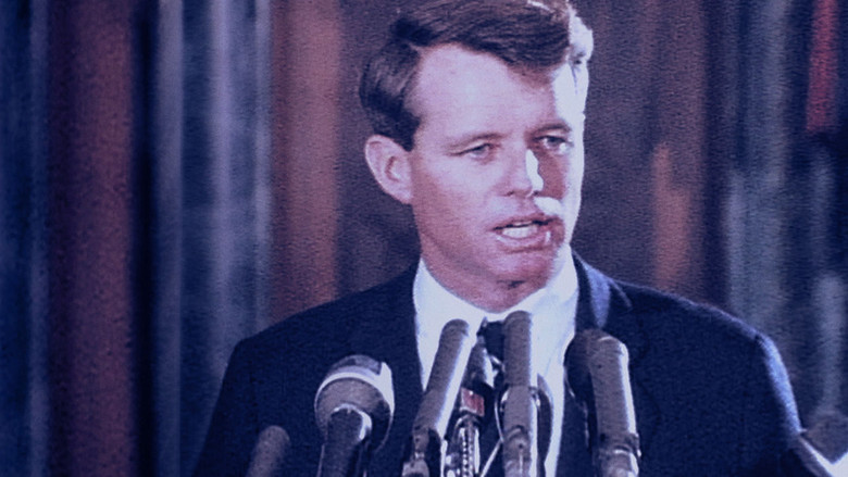 Black-and-white footage of Robert F. Kennedy speaking at a podium, his face half in shadow, the crowd a blur of outstretched hands