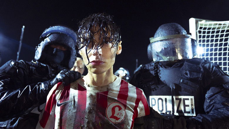 Yusuf being escorted by police through the stadium corridors