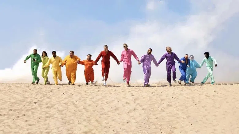 The crew huddled around a stunt gone wrong, laughing through the pain