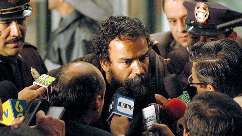 A man in a suit stands in a crowded, chaotic street, his expression a mix of desperation and disbelief