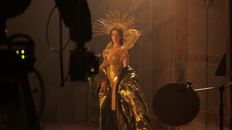 An eerie, shadow-filled dressing room cluttered with fabric and vintage fashion.