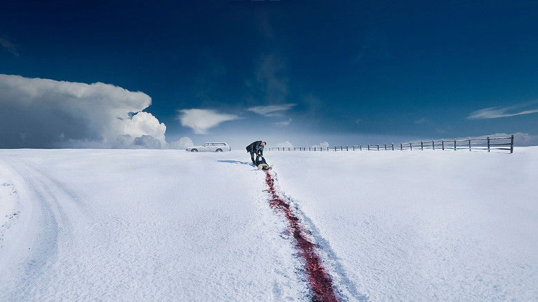 A snow-covered road under a bleak winter sky