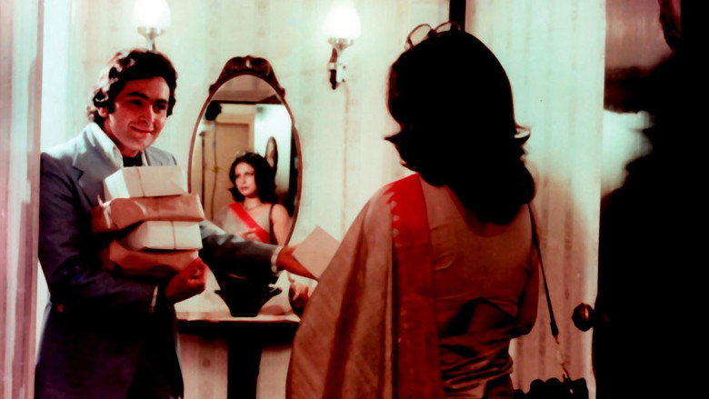 A woman in a sari stands in a doorway, her face half in shadow, as if caught between two worlds.