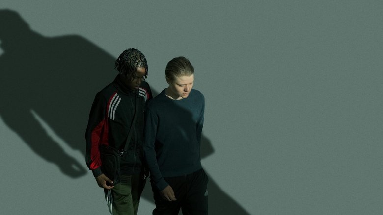 Two boys sit on a bench in a dimly lit park, their faces half-hidden in shadow, the weight of something unspoken between them.