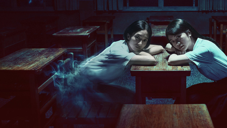 A dimly lit classroom, its wooden desks arranged in neat rows, the air thick with dust and something unseen.