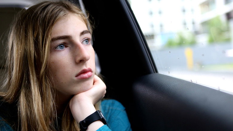A young Georgie Stone looks directly into the camera, her expression soft but unyielding, as if she’s already decided who she is.
