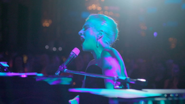 Gaga sitting in a recording studio, her face half-lit by the glow of a laptop screen, looking exhausted but focused.