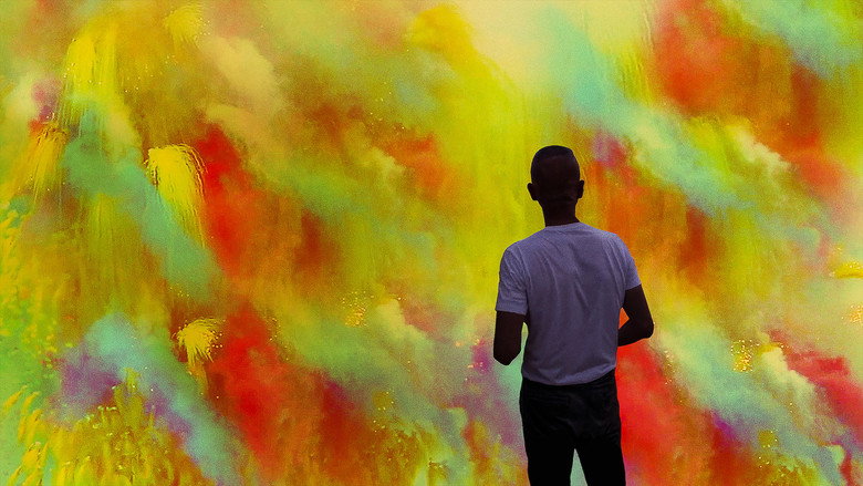 A close-up of Cai Guo-Qiang’s hands arranging gunpowder fuses on paper, the delicate lines of his artwork emerging from the black powder.