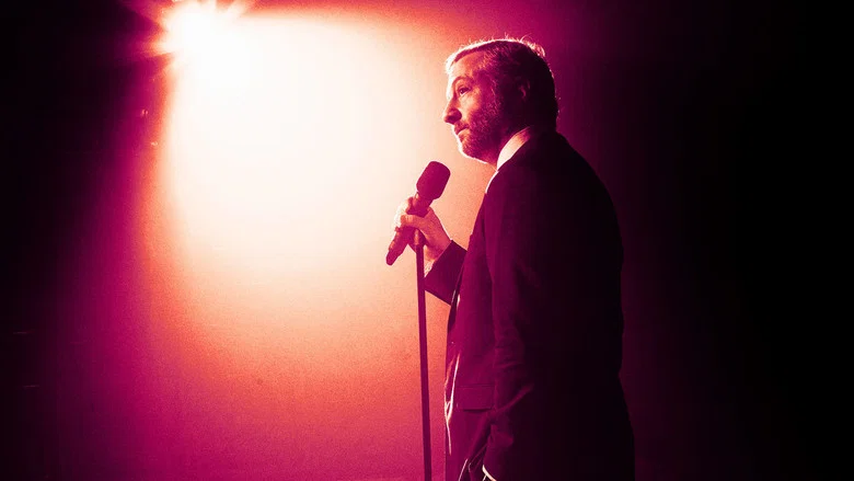 Judd Apatow on stage, mid-laugh, under warm stage lights