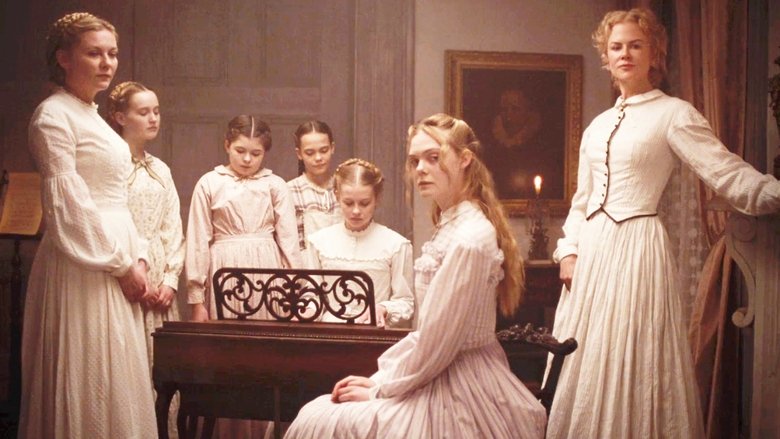 The girls of Miss Martha’s school gather around the wounded Union soldier, their faces half-lit by candlelight, curiosity and wariness mingling in their expressions.