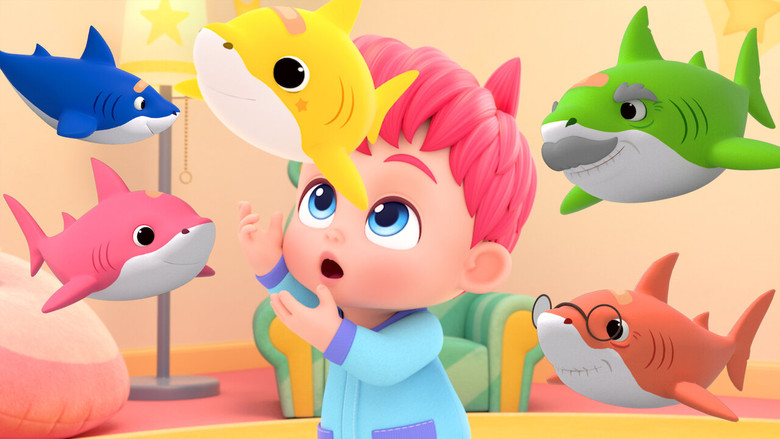 A still from *Bebefinn* showing baby Finn in a high chair, surrounded by soft, pastel-colored shapes and toys, his face lit with a wide, curious smile.