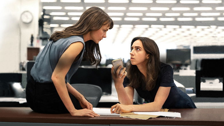 Two women sit at a table in a dimly lit bar, their expressions tense as they listen to a third person speaking.