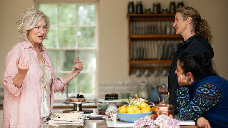 The townspeople of Deadloch gathering, looking out of place in their colorful clothing against the backdrop of the bleak, dramatic cliffs.