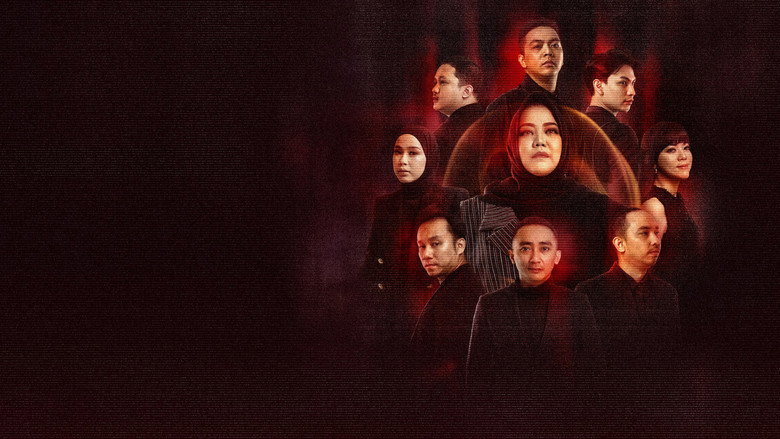 A dimly lit room where Risa Saraswati and her team huddle around a camera, their faces half-lit by the glow of the screen, their expressions a mix of fear and fascination.