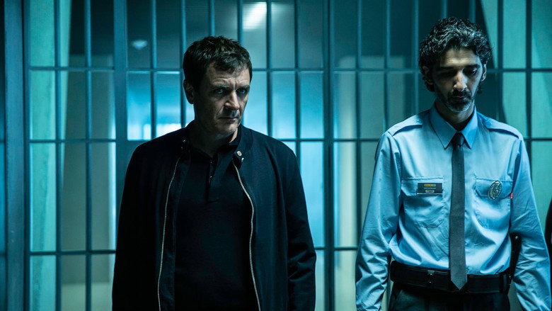 Unai (Javier Rey) and his partner Estíbaliz (Aura Garrido) stand in the dimly lit crypt of the cathedral, their faces half-lit by the flickering light of a single bulb, the weight of the investigation pressing down on them.