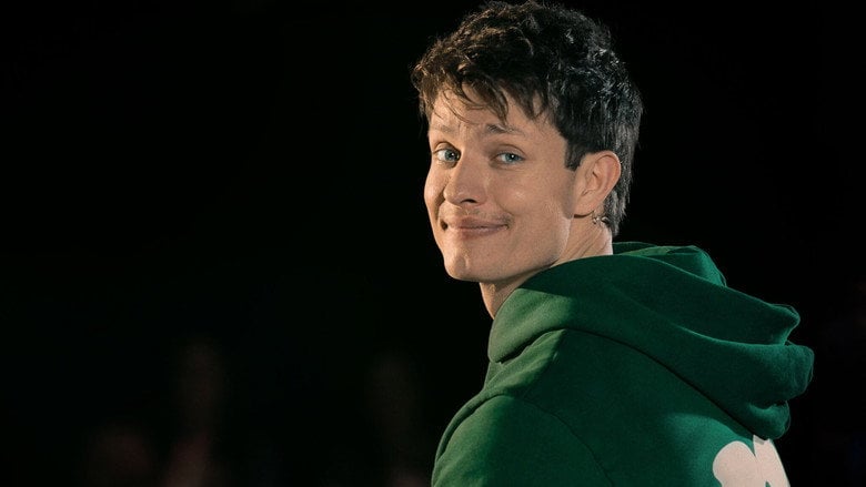 Matt Rife on stage, mid-laugh, gesturing toward an audience member