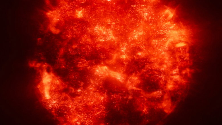 A swirling nebula of gas and dust, its colors shifting from deep violet to fiery orange, as if the universe itself is breathing.